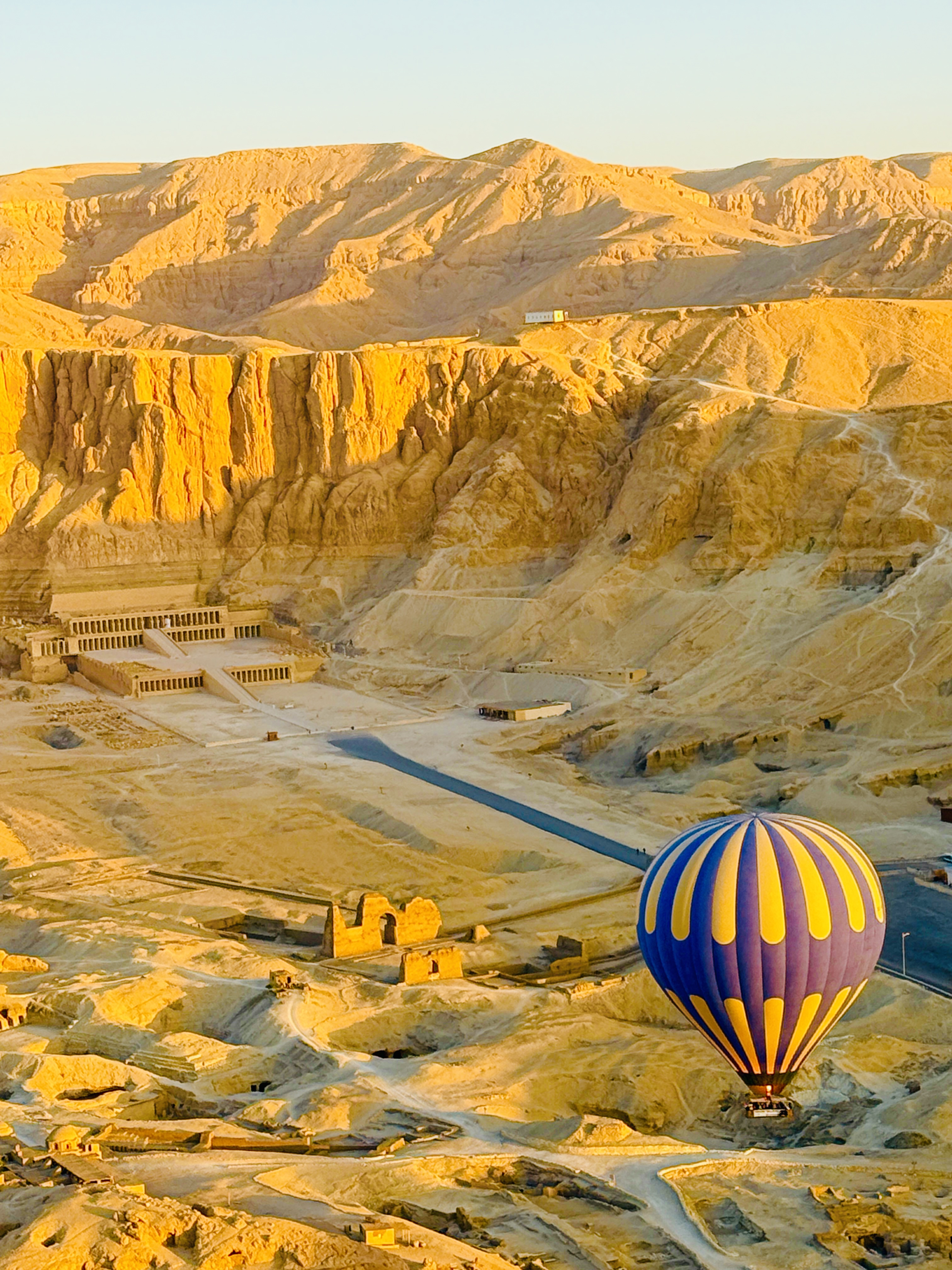 Hot air balloon above the sunlit landscape of Luxor